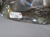 a silver statue of a dog with a tag on it ' s neck