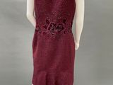 a mannequin wearing a red dress with flowers on it