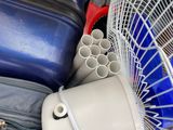 a fan that is sitting next to a pile of luggage