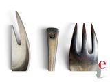 three forks and a fork on a white surface