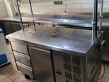 a kitchen with stainless steel counter tops and cabinets
