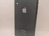an apple iphone is sitting on a white surface next to a black iphone