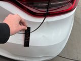 a person that is plugging in to a car