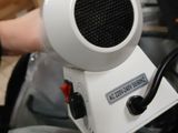 a white blow dryer sitting on top of a bed