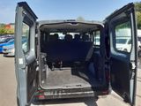 a small van with its doors open in a parking lot