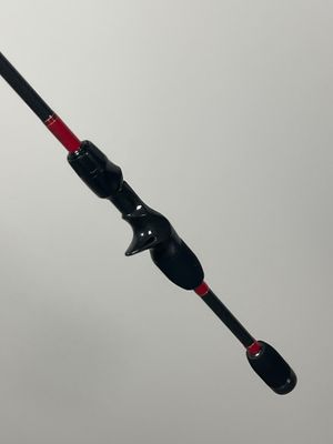 a close up of a fishing rod with a red handle