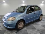 la photo d'une petite voiture bleue garée sur un sol en damier