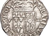 a silver coin with a coat of arms on it