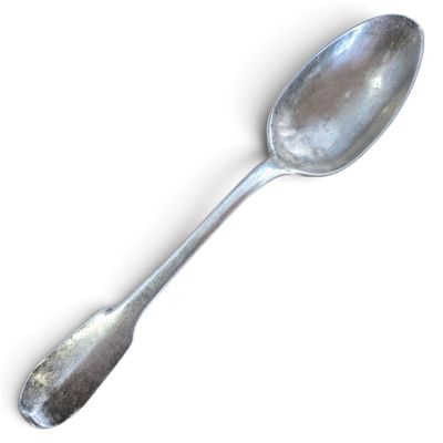 a silver spoon with a spoon handle on a white surface