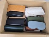 a cardboard box filled with different types of purses