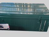 a close up of a green metal box with a tag on it
