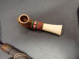 a picture of a pipe and a pipe holder on a table