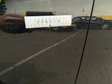 a person holding a sticker that says vaunto on it
