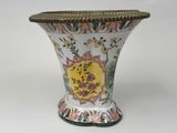 a vase that has a gold rim around it
