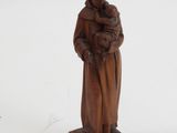 wooden statue of a man holding a child in his arms