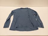 blue long - sleeved shirt on display in a museum display case