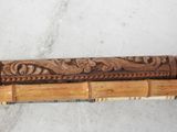 an image of a close up of a bamboo stick with carvings on it
