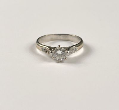 a white gold engagement ring with a heart shaped diamond
