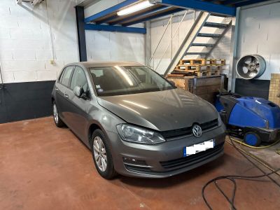 a car that is parked in a garage with a blower