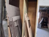 several pieces of wood are stacked on a shelf in a room
