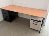 a desk with a file cabinet and a computer on it
