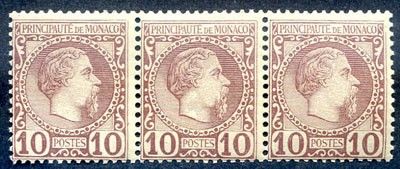 a close up of three stamps on a black surface