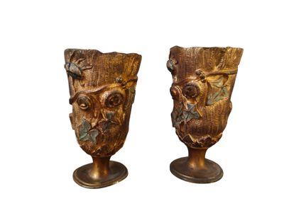 two vases with carvings on them on a white background