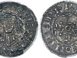 a close up of a coin with a cross on it