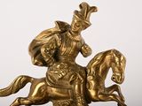 a statue of a man riding a horse with a hat on