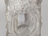 a glass vase with a design of a woman holding a flower
