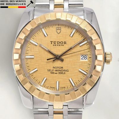 a close up of a watch on a white surface
