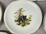 many plates with animals painted on them on a table