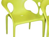pair of lime green plastic chairs with holes in the back