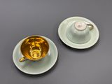 a cup and saucer on a table with a saucer and saucer