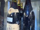 two bottles of wine on display in a glass case