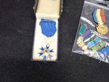 a box of medals and a cell phone sitting on a table