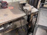 a picture of a workbench in a factory with a lot of tools on it
