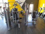a gym with a lot of machines in the room