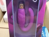 someone is holding a purple object in a box with a purple handle