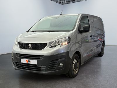 the small van is parked in the large room of the building
