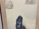 painting of a hand holding a red object in a black frame