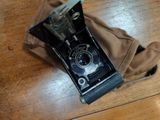 an old fashioned camera sitting on a wooden table