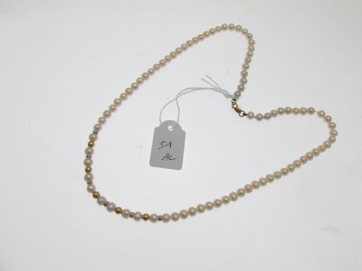 a close up of a necklace with a tag attached to it