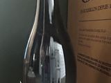 a bottle of wine sitting on a table next to a box