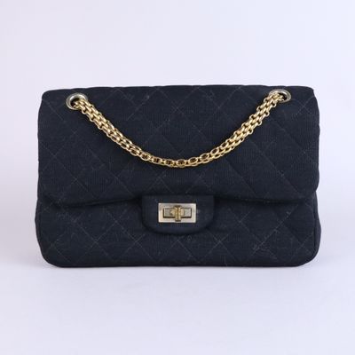 a black quilted bag with a gold chain strap