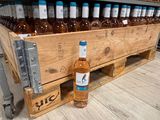 a wooden crate filled with bottles of wine on the floor