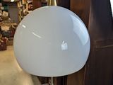 a white lamp that is on a stand in a room