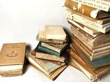many books stacked on top of each other on a table