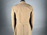 the back view of a tan coat on a mannequin mannequin
