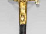 an image of a black and gold sword with a gold handle